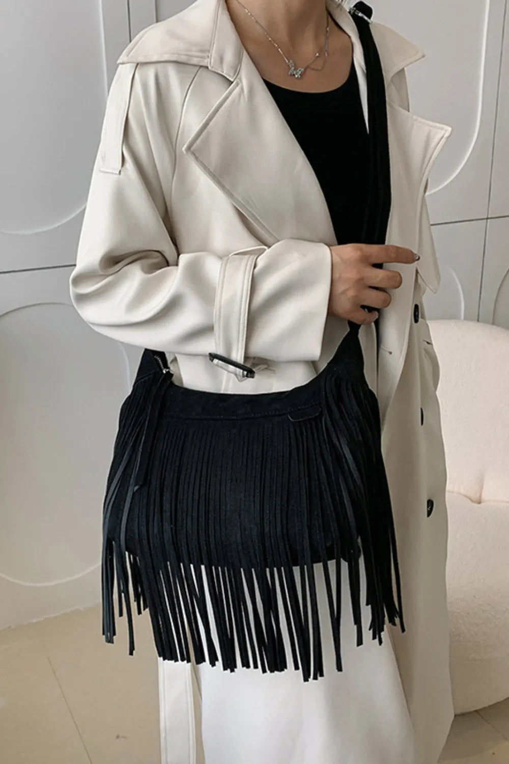 Black suede fringe shoulder bag with top flap and long tassels