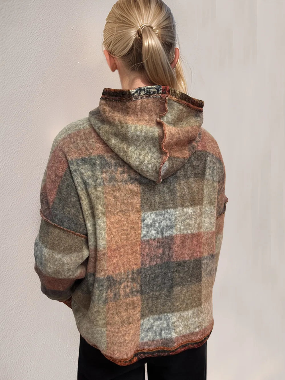 Plaid fleece hoodie with dropped shoulders, hood from back view, dark multicolor blocks.