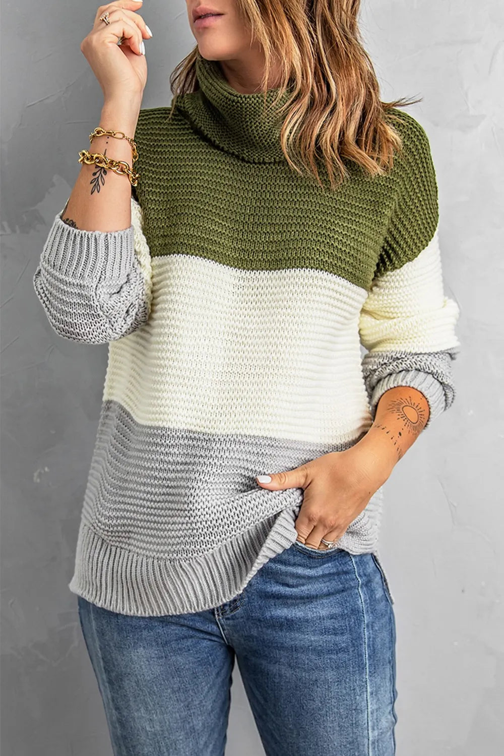 Color-block turtleneck sweater in moss green, cream, and gray; long sleeves