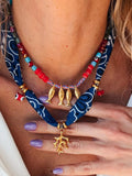 2-piece necklace with gold fish charms on navy beaded cords