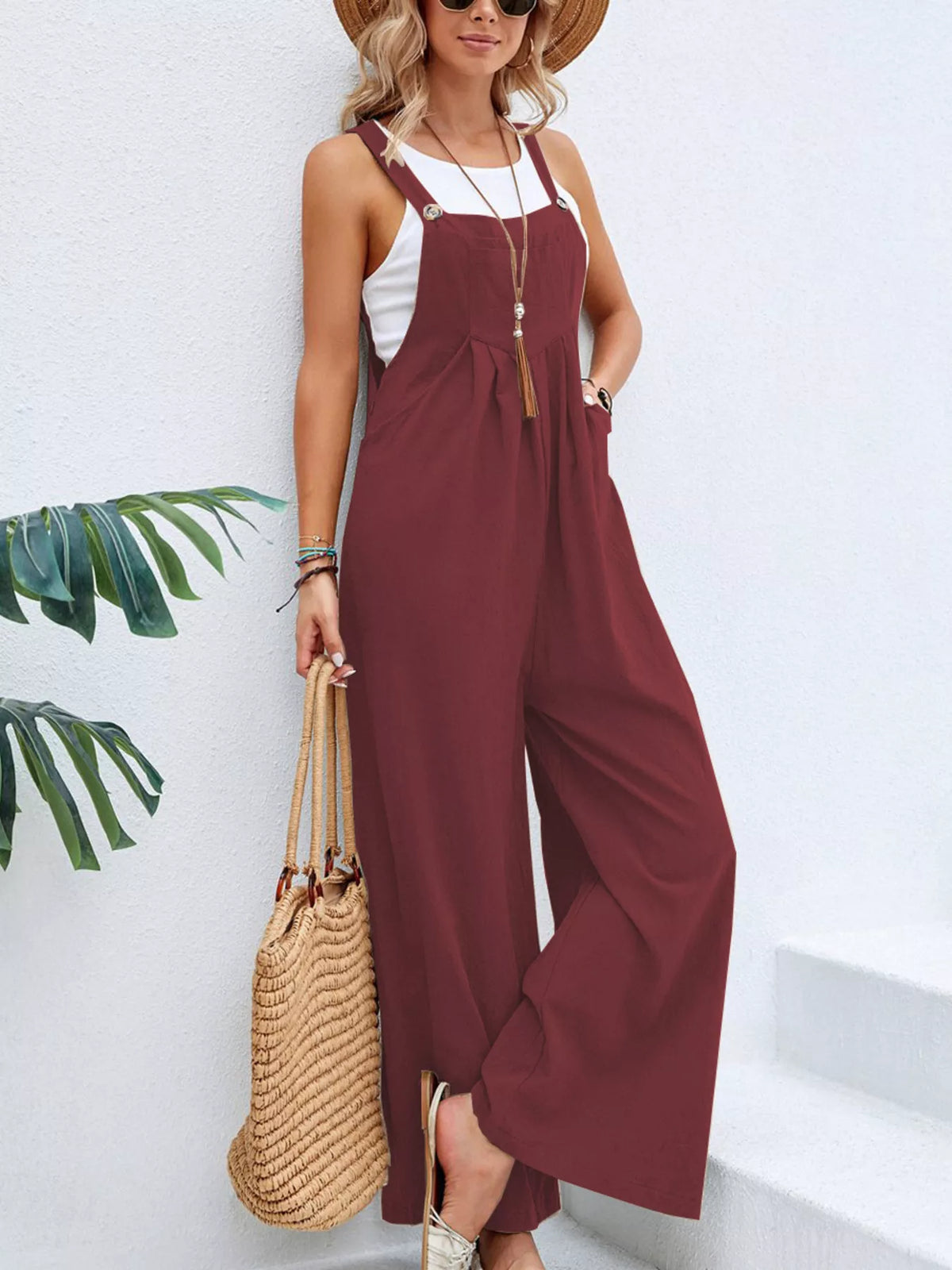 Sleeveless wide-leg overalls with pockets, adjustable straps, burgundy overall bib.