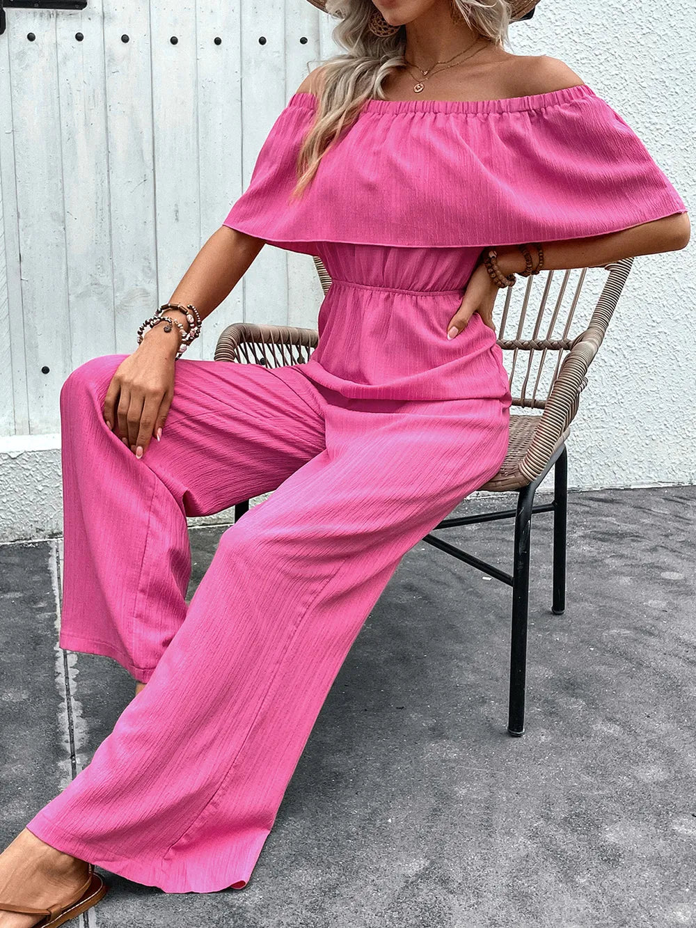Hot pink off-shoulder wide-leg jumpsuit with gathered waist and wide cuffs
