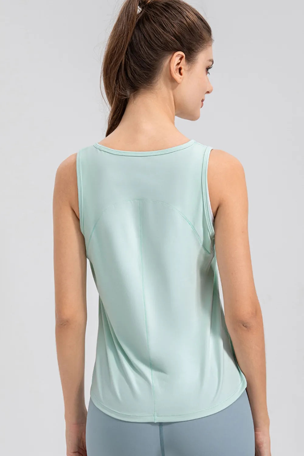 Light green active tank top with wide straps and round neckline, back view.