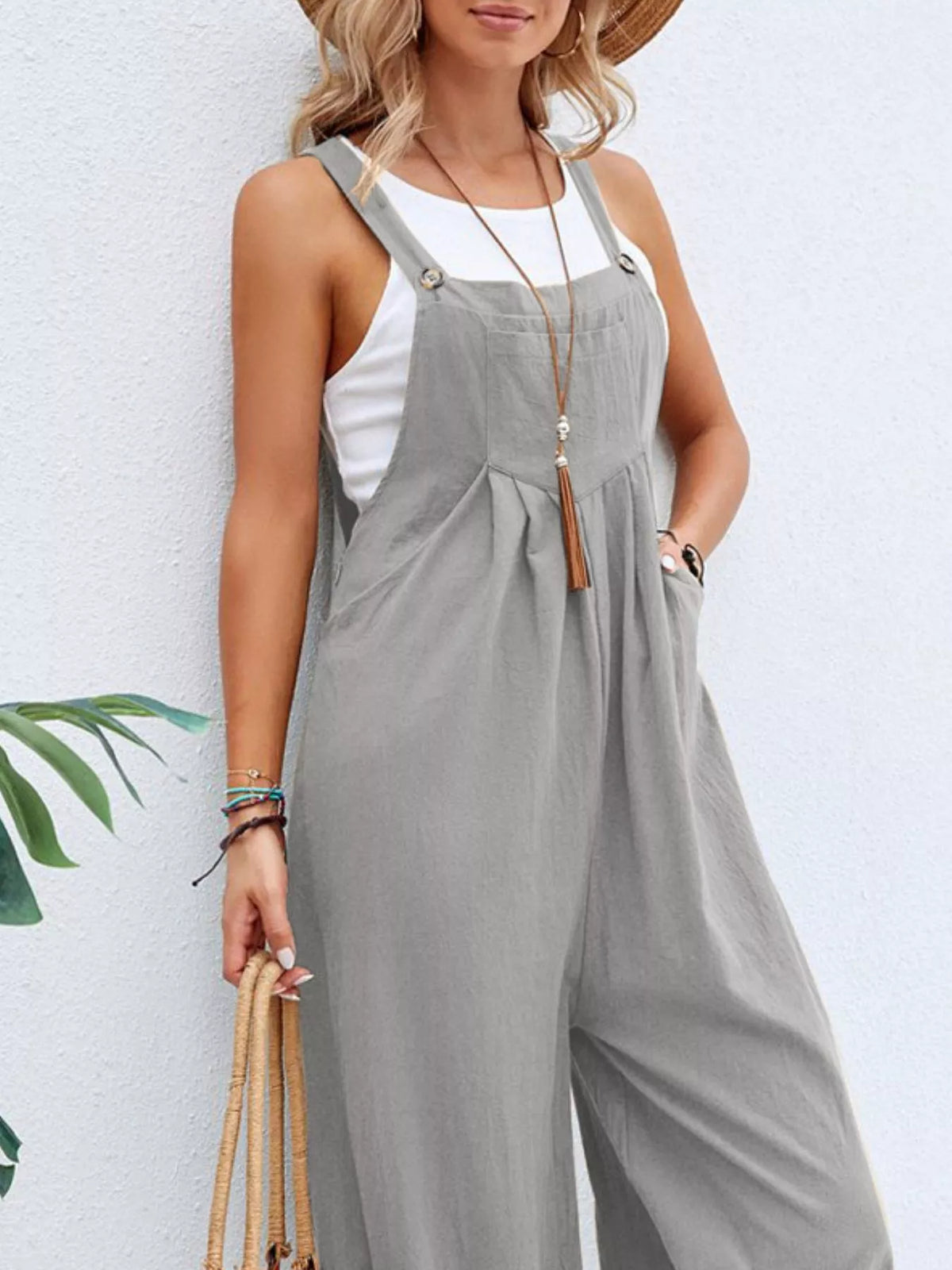 Light gray wide-leg overalls with front bib detail and adjustable straps.