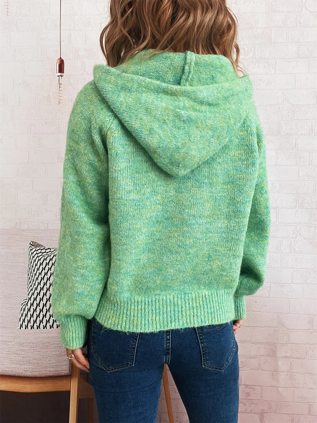 Green quarter-zip sweater viewed from back with ribbed hem and cuffs