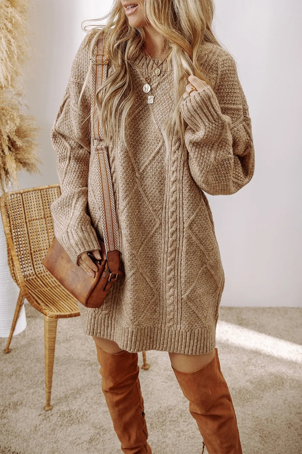 Tan cable-knit round neck sweater dress with long sleeves and buttoned neckline
