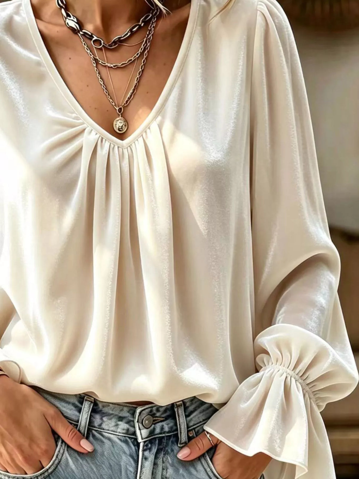 Cream V-neck ruched blouse with draped sleeves and soft pleat detailing