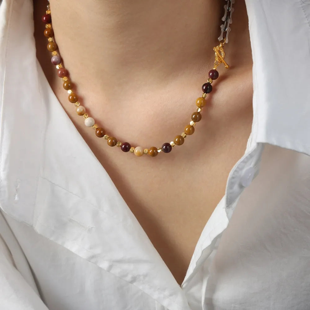 Beaded necklace with multicolor round stones and silver-tone chain shown on the neck