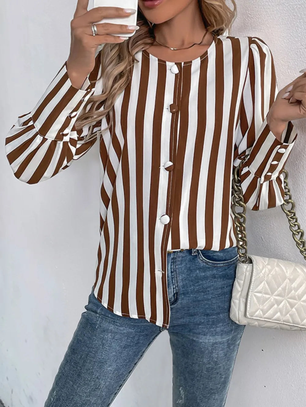 Brown and white striped long-sleeve blouse with round neck and button-up front