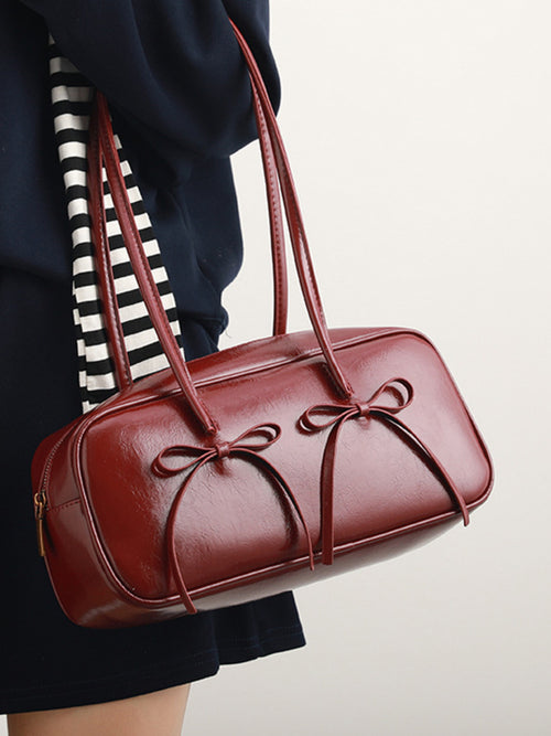 Red bow-decor shoulder bag with curved top handles and front knot details
