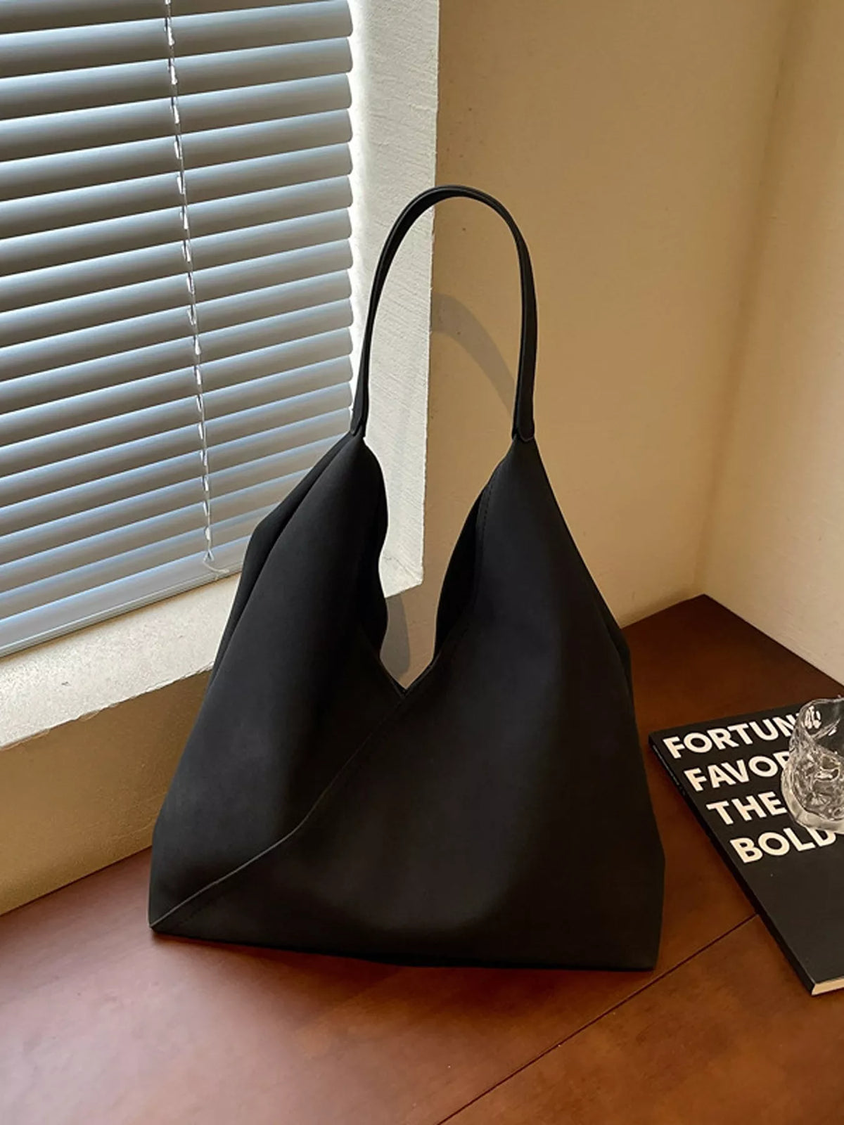 Black slouchy suede shoulder bag with open top and handles