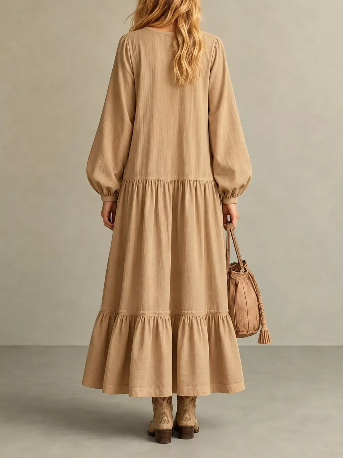Light tan tiered maxi dress back view with gathered waist and long puff sleeves