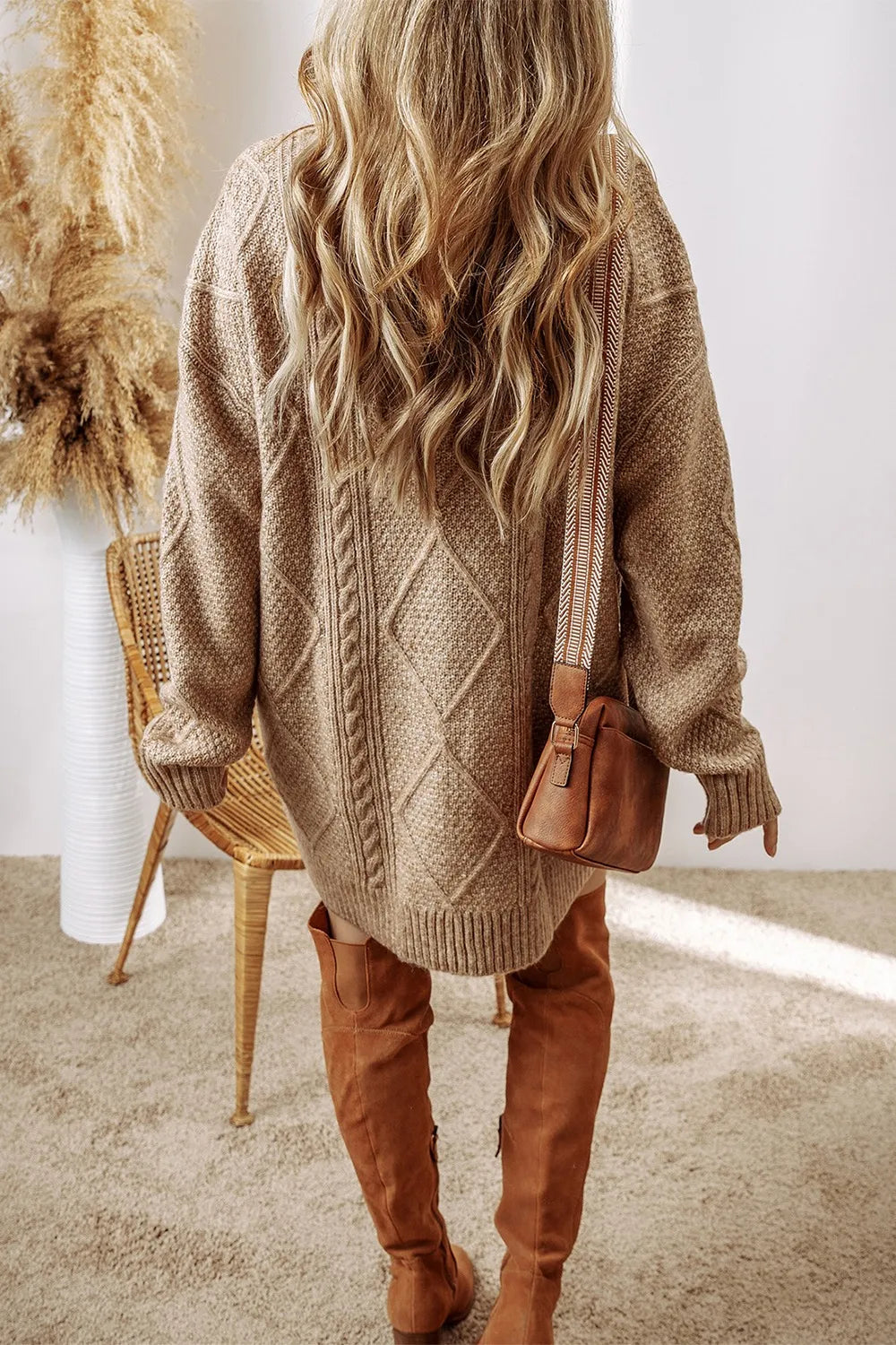 Tan cable-knit round neck sweater dress with long sleeves and textured diamond pattern