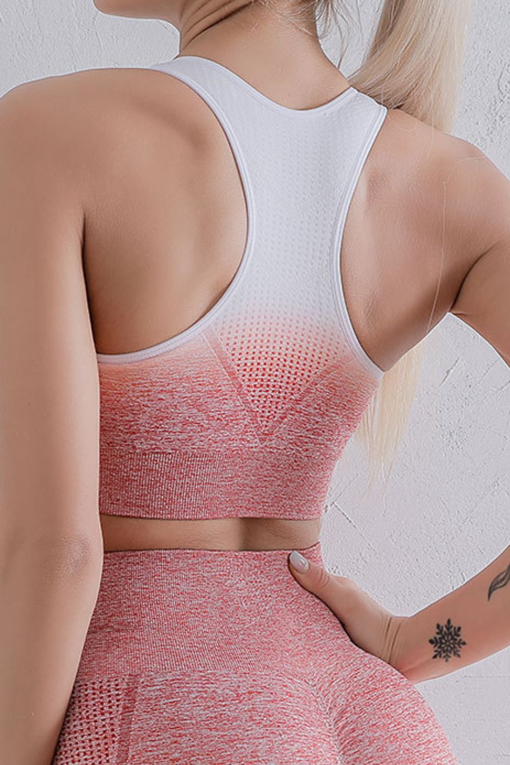 Sports bra and leggings set back view with pink gradient sports bra and matching leggings