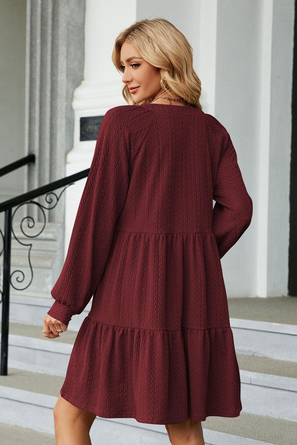 Burgundy notched neck long sleeve mini dress, back view with tiered skirt