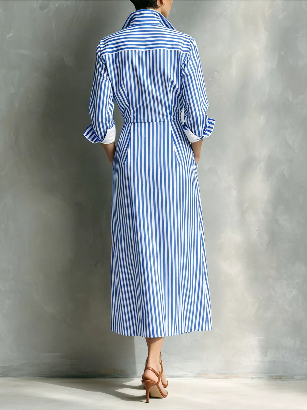 Back view of blue striped shirt dress with button-front and elbow-length sleeves.