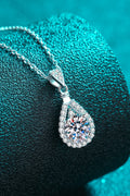 Sterling silver moissanite teardrop pendant with halo surround, side view on chain