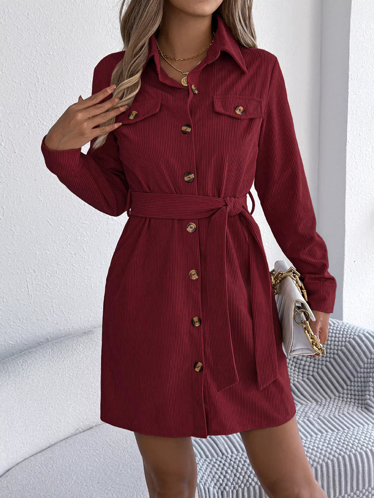 Burgundy corduroy shirt dress with long sleeves, button front, and waist tie belt