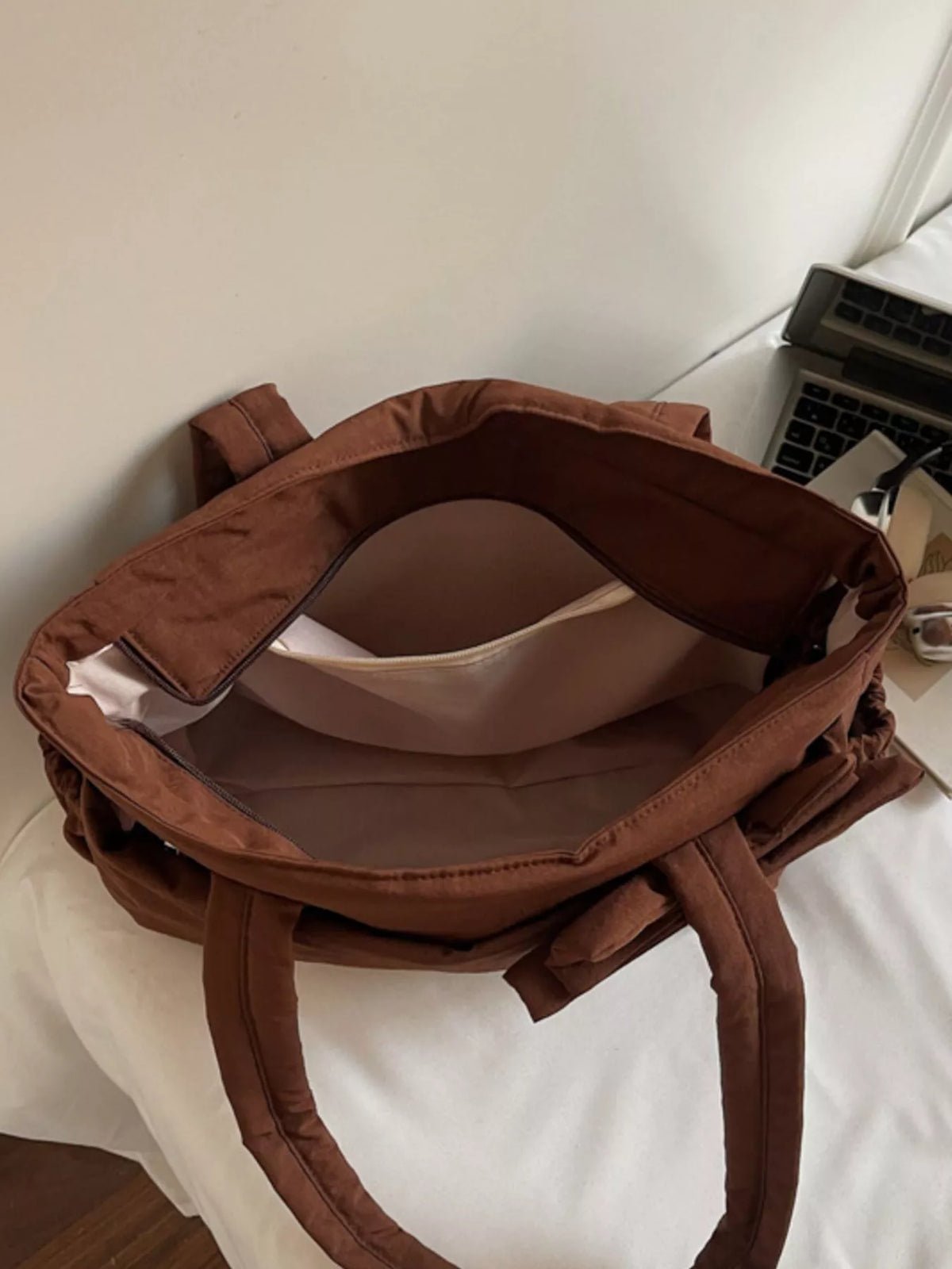 Brown medium casual tote bag interior view with bow detail on front panel