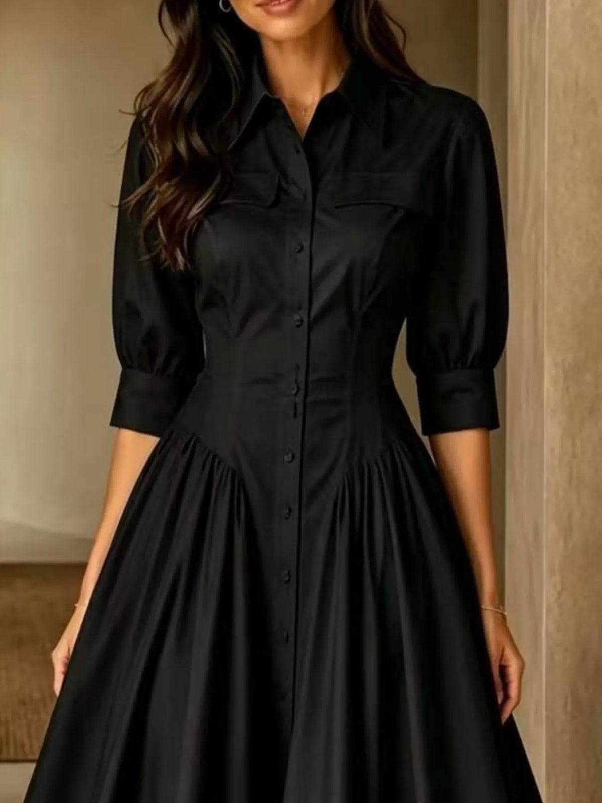 Black button-down shirt dress with cinched waist, 3/4 puff sleeves, and gathered skirt.