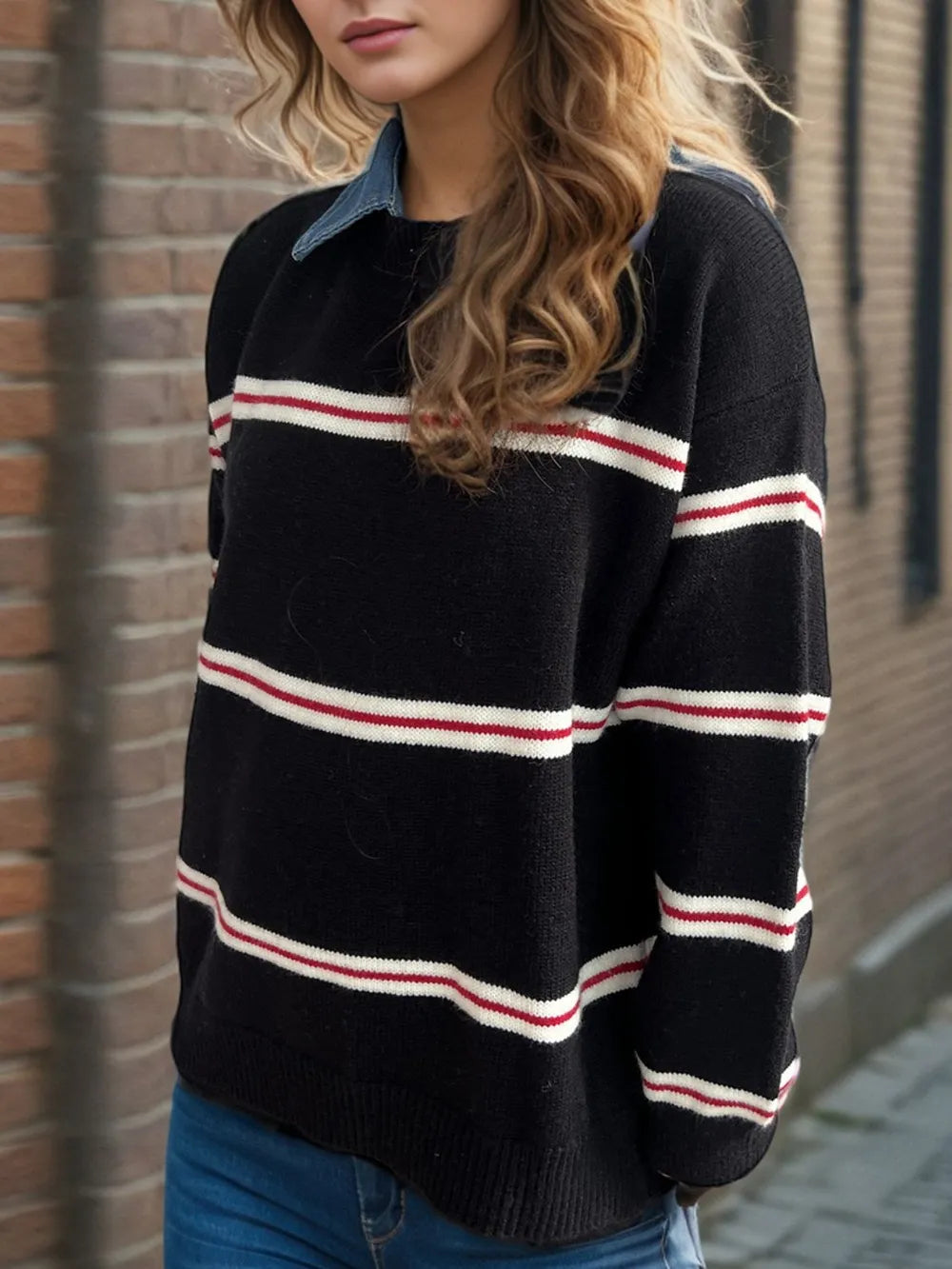 Black round-neck long-sleeve sweater with red and white stripe bands across chest