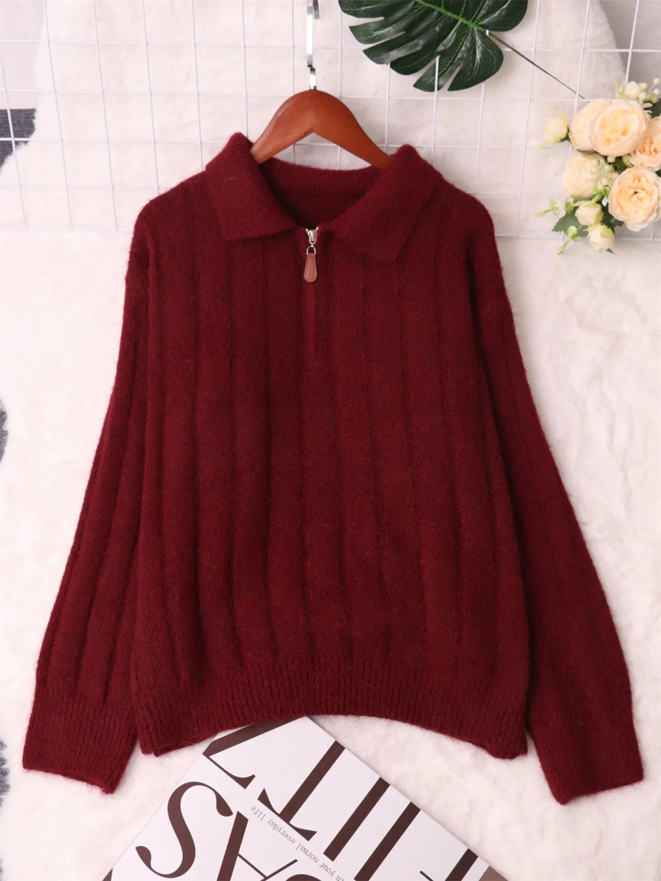 Ribbed hem quarter-zip sweater, burgundy on hanger with ribbed collar and cuffs.