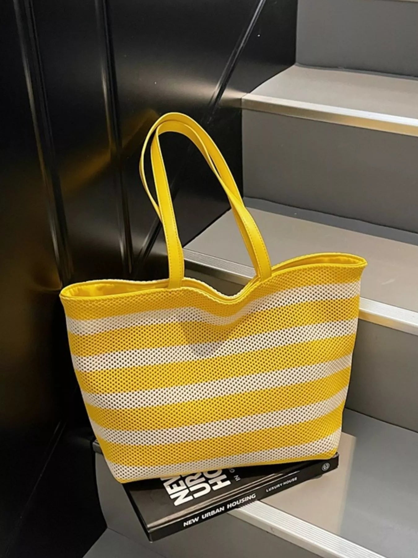 Yellow and white striped mesh shoulder bag with wide straps and open top