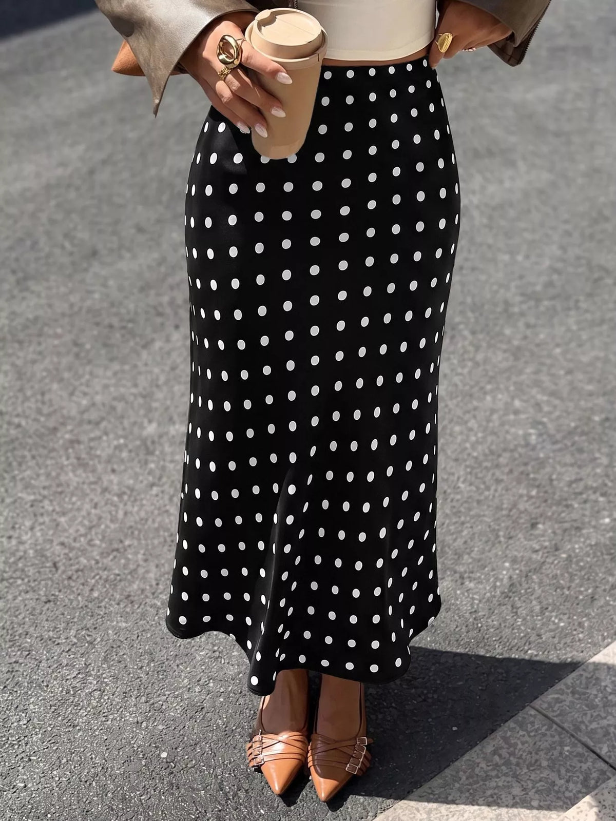 Black midi skirt with white polka dots, high-waist fit and subtle flare