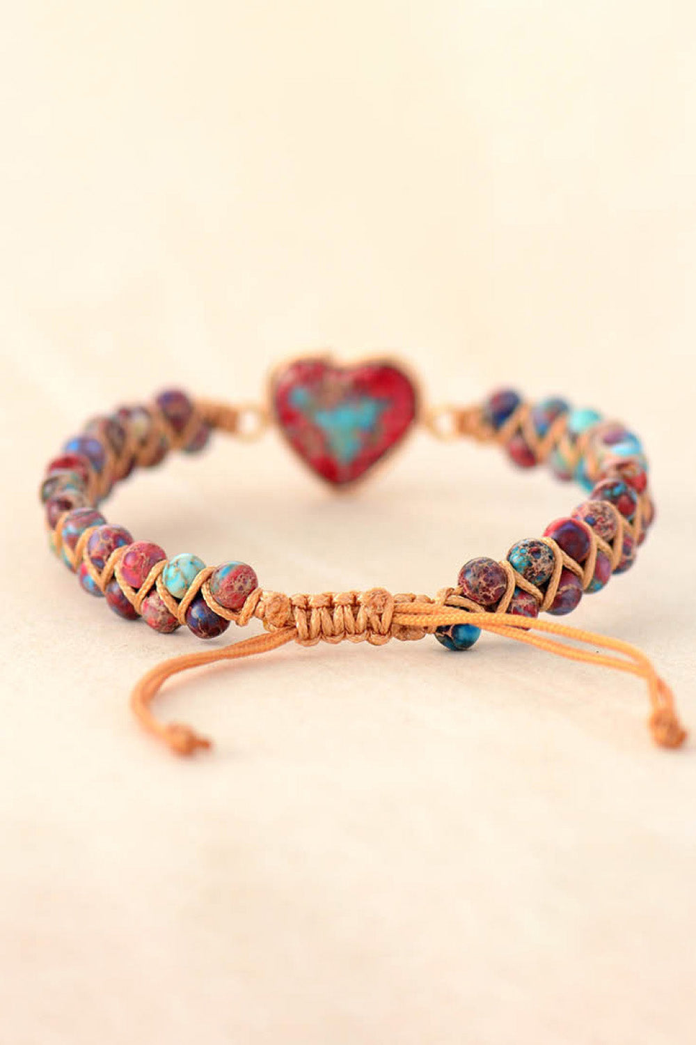 Colorful braided heart bracelet with gold-tone clasp and heart-shaped turquoise stone