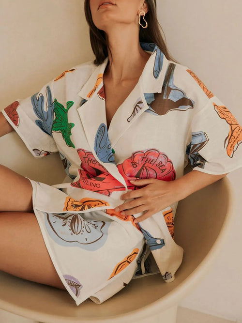 Women’s white short-sleeve button-up shirt and shorts set with colorful sea shell prints