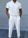 White quarter-zip polo and matching drawstring pants set on model
