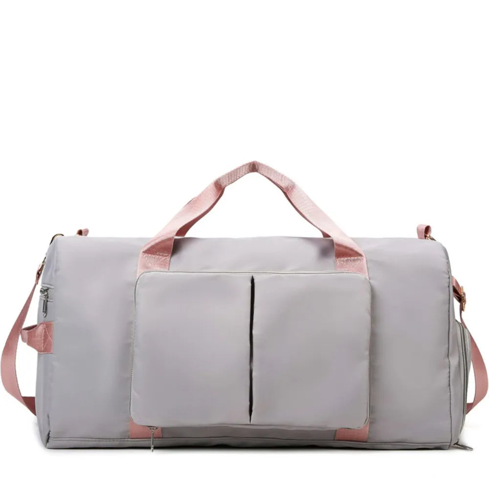 Large travel duffel bag with front zip pocket, light gray body and matching handles