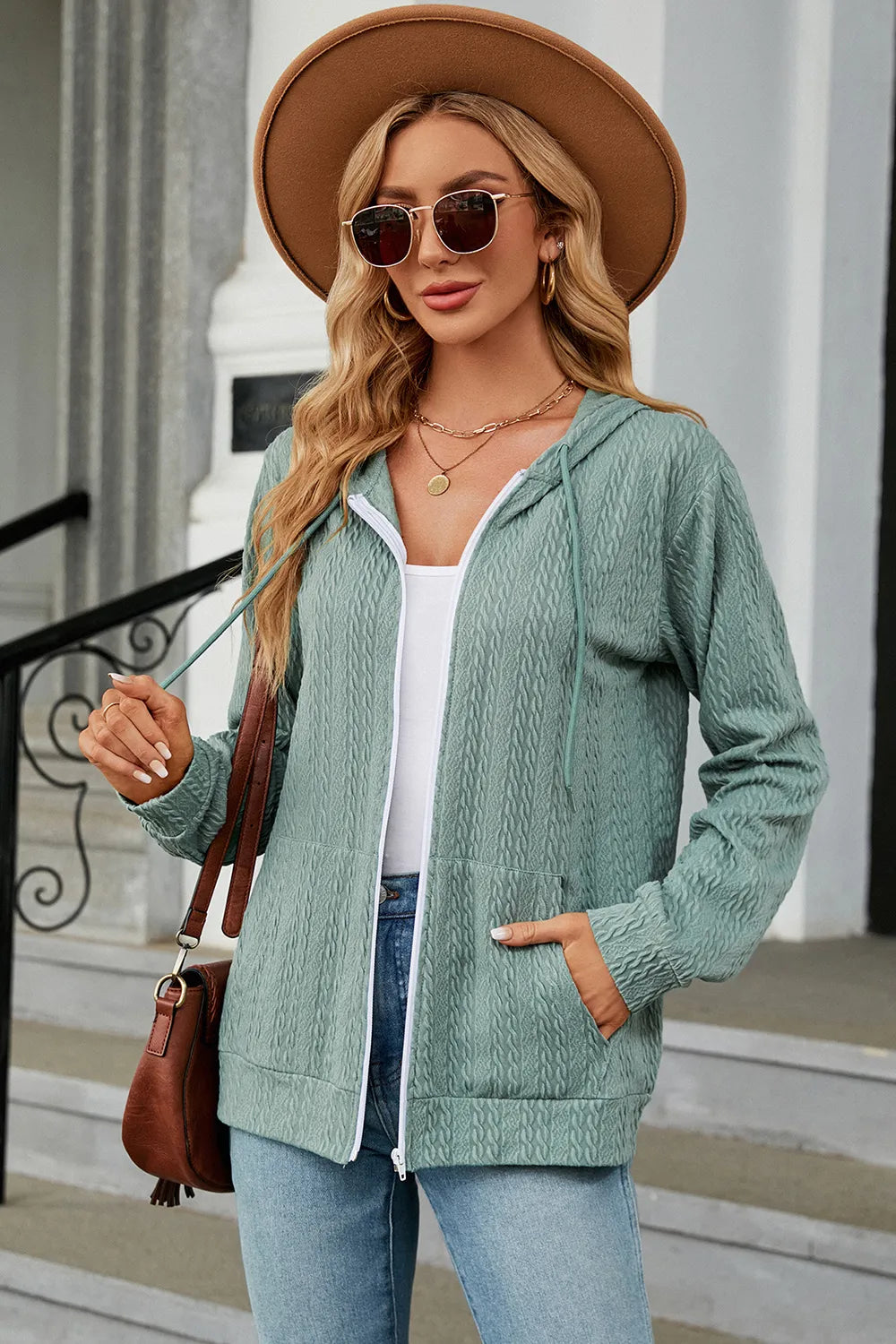 Light green zip-up hoodie with drawstring hood and front zipper, long sleeves