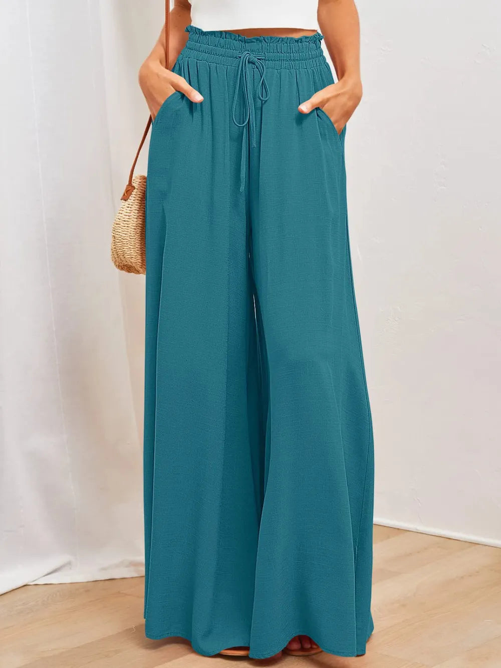 Teal wide-leg pants with elastic waistband, drawstring tie, and side pockets