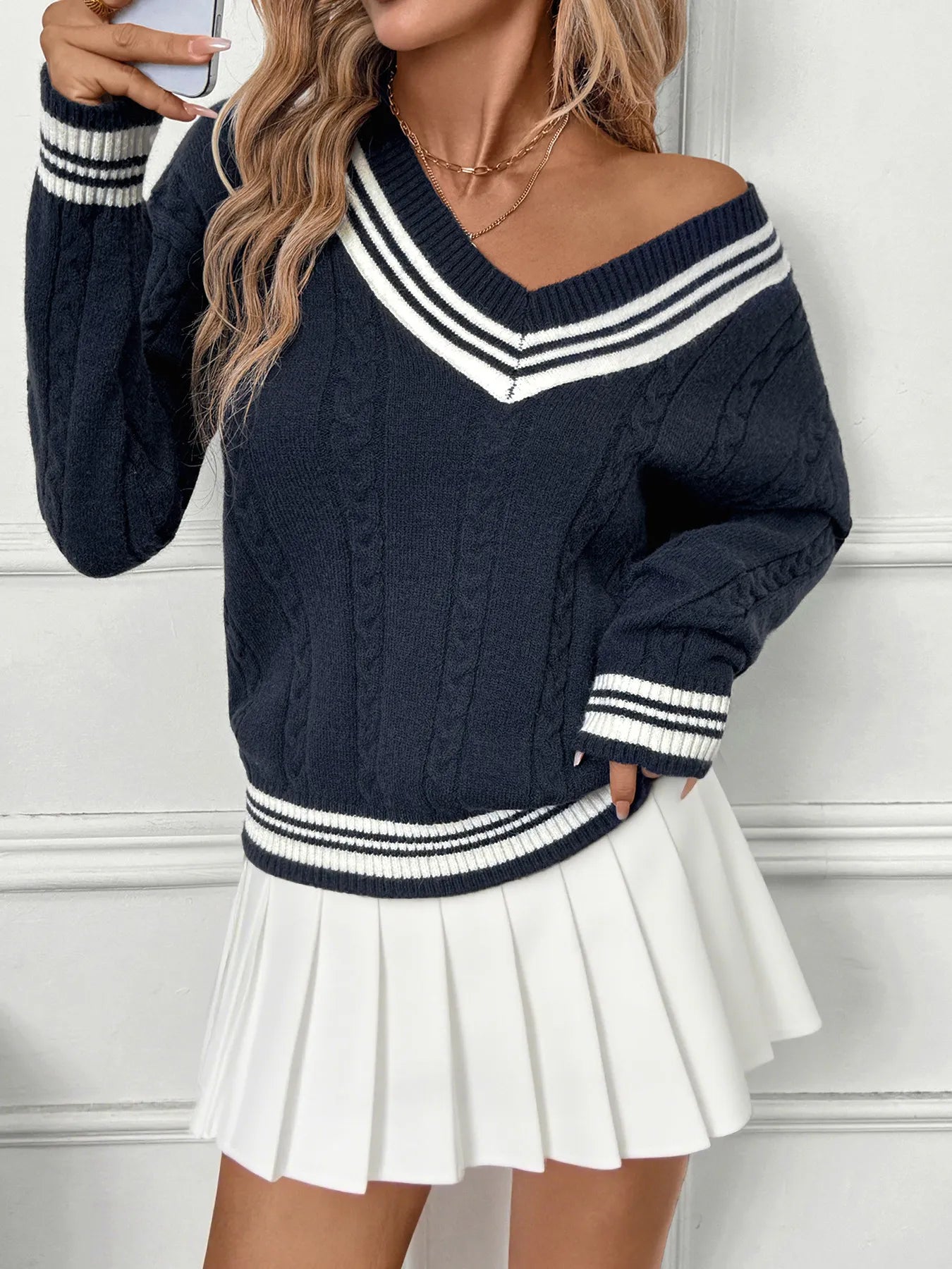 Dark blue V-neck sweater with contrast striped neckline and ribbed cuffs