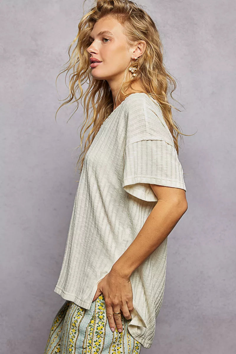 Cedar & Moore POL ribbed knit V-neck short sleeve t-shirt with side slit in cream.