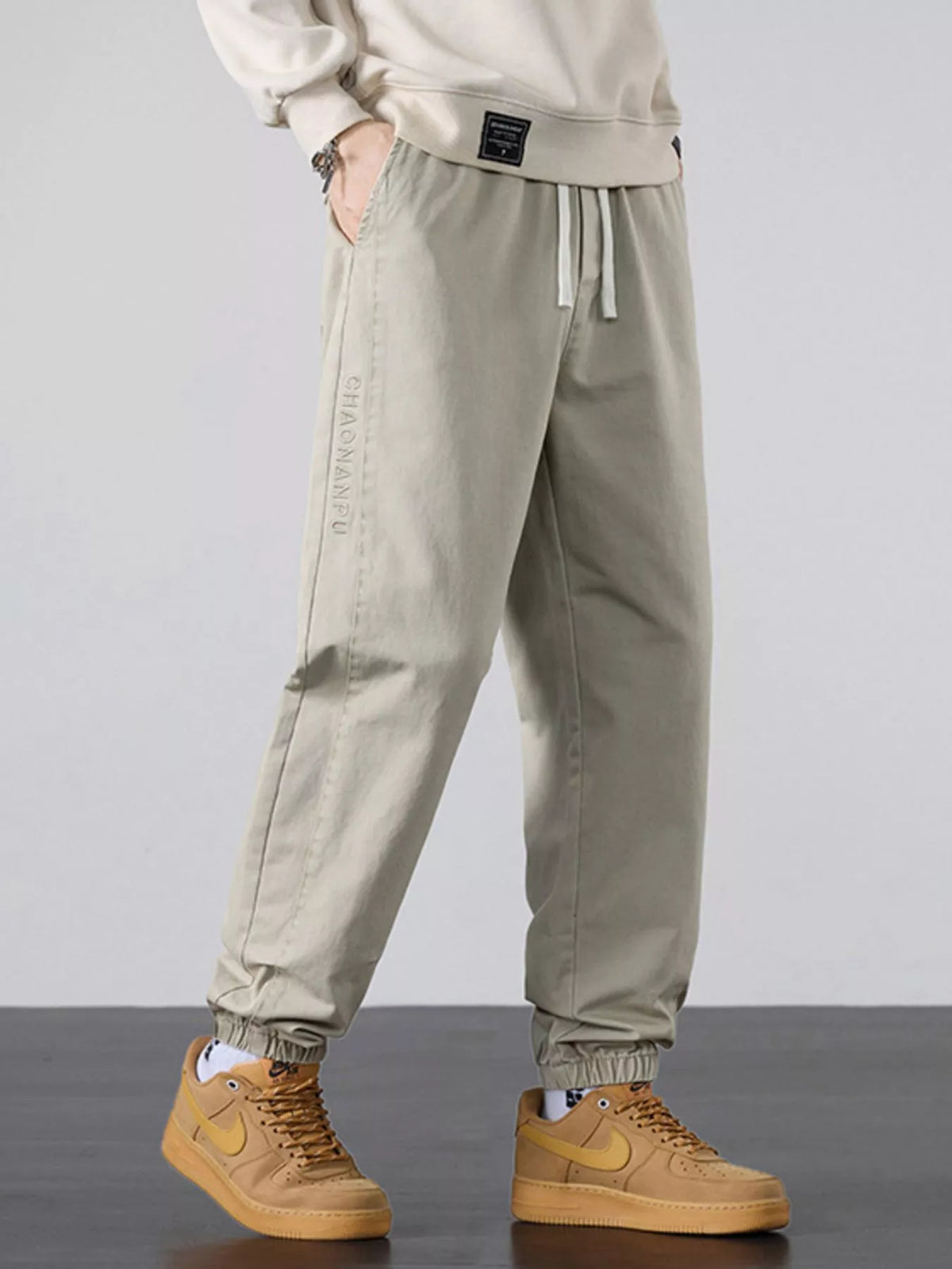 Men's casual light khaki joggers with pockets, relaxed fit, and drawstring waist