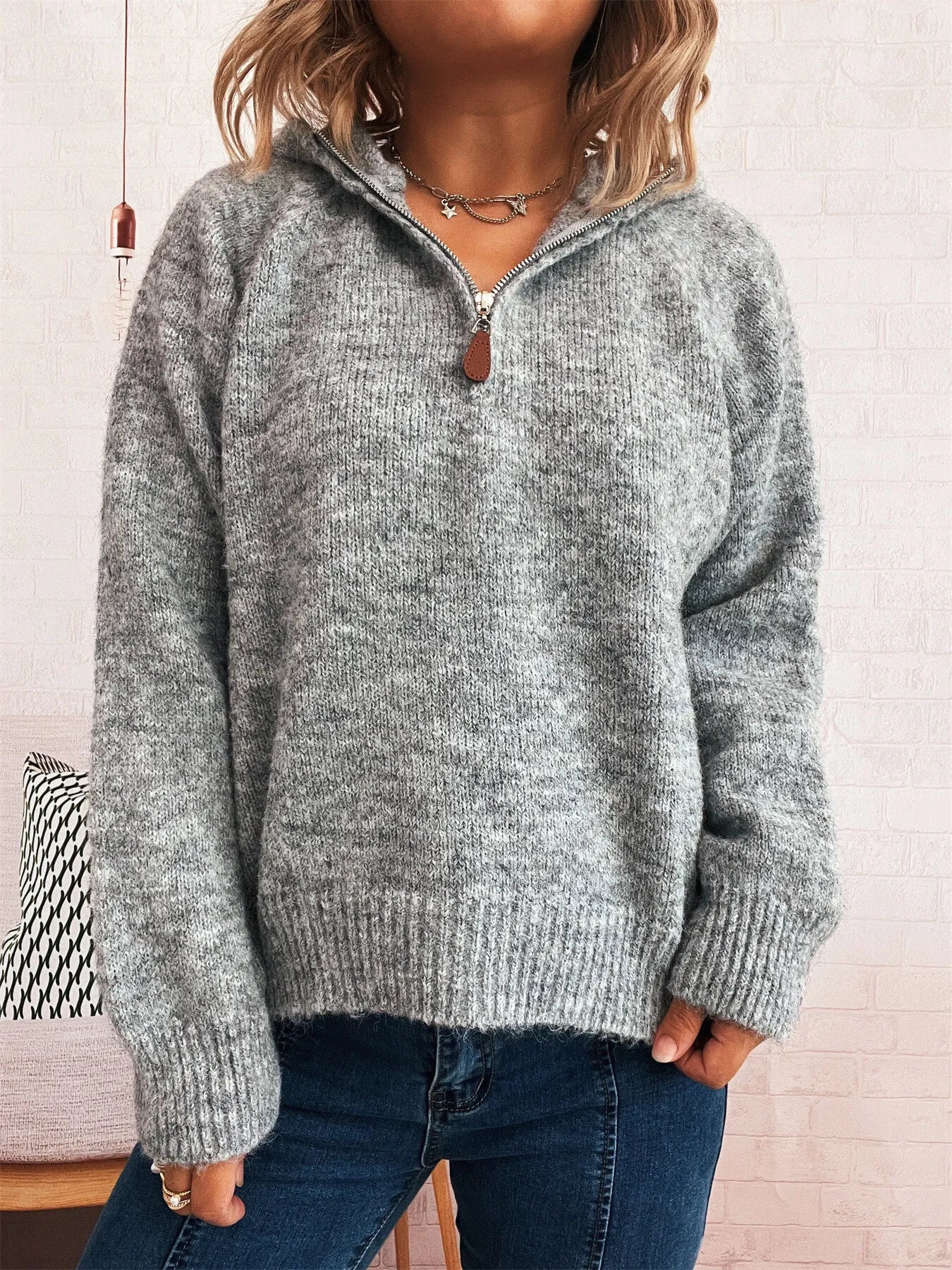 Dark gray quarter-zip ribbed sweater with visible zipper at neckline