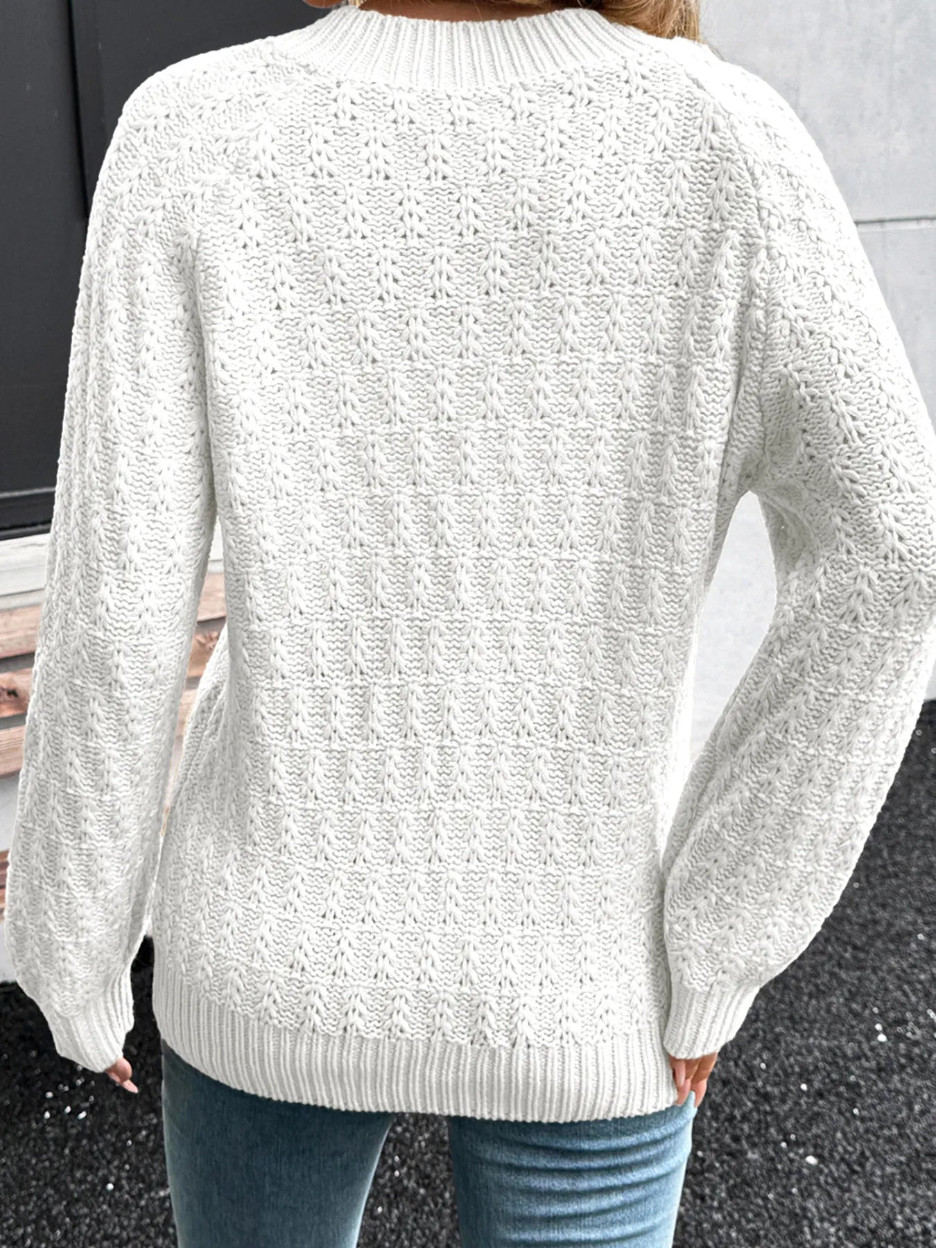 White textured knit crew-back sweater with long sleeves and ribbed cuffs.
