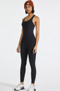 Black active jumpsuit with wide straps and slim long-leg fit