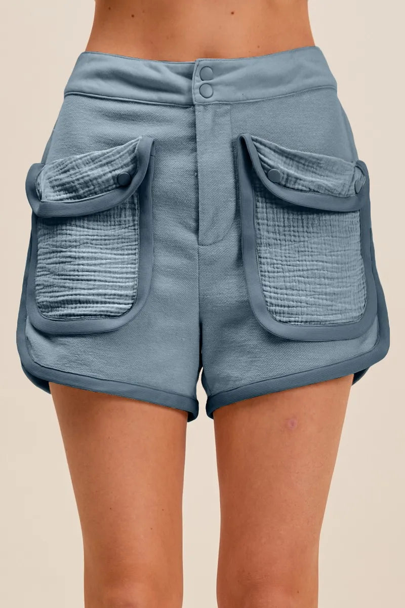 Denim blue mineral-washed terry high-rise cargo shorts close-up, back flap cargo pockets