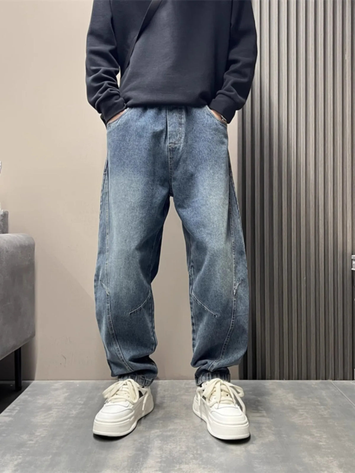 Light blue washed loose-fit stretch jeans with cuffed ankles and classic 5-pocket styling