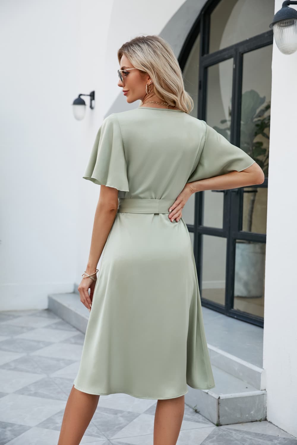 Sage green tie-waist surplice flutter sleeve dress, belted waist and midi length