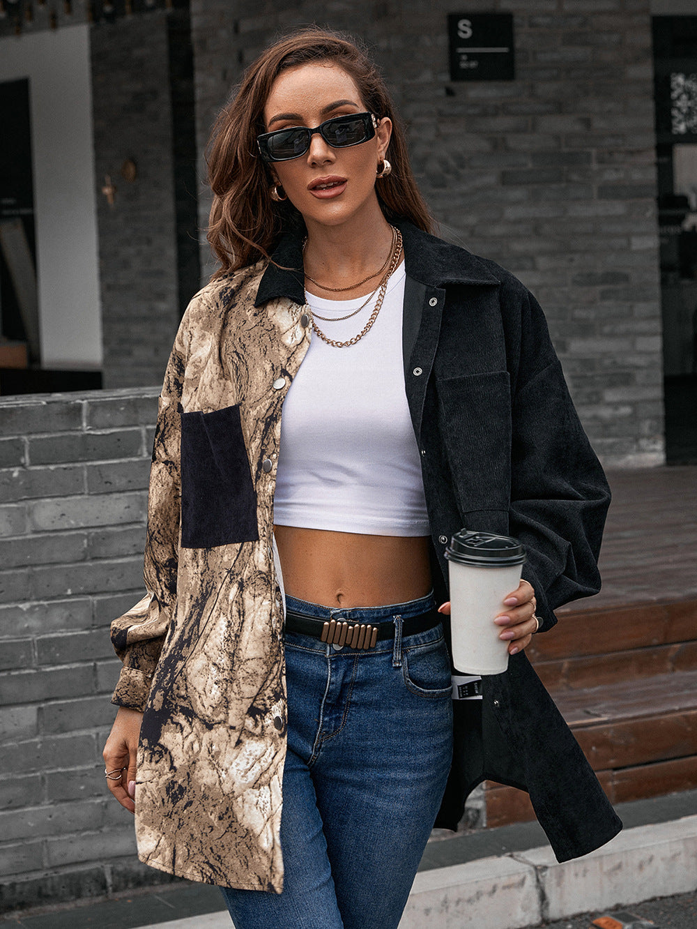 Collared contrast shirt with dropped shoulders, black outer layer and beige speckled panels