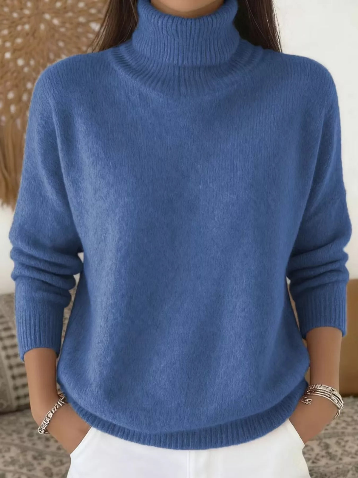 Blue long-sleeve turtleneck sweater with ribbed collar, cuffs, and hem.