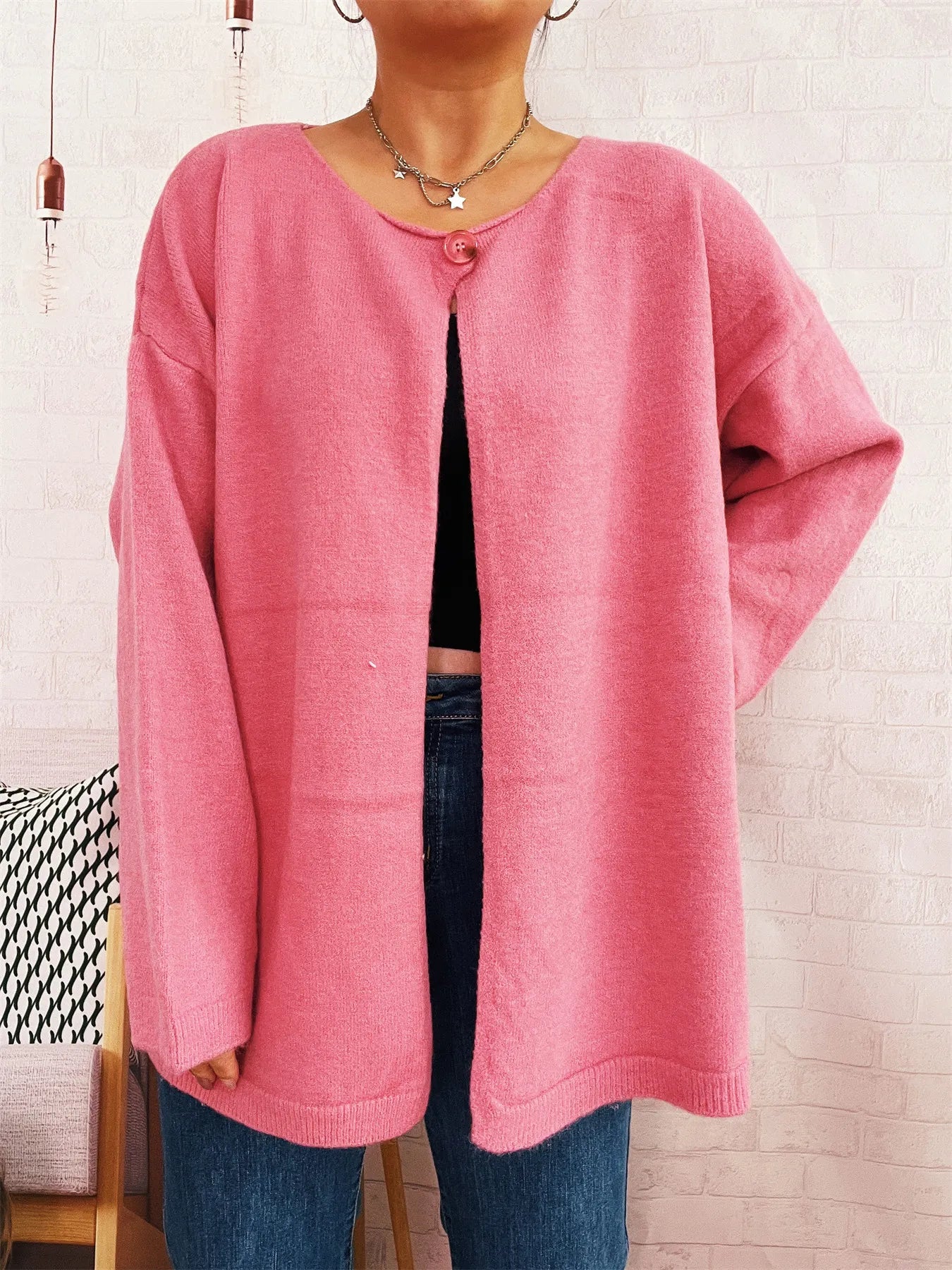 Pink one-button cardigan with relaxed drop shoulders and ribbed hem