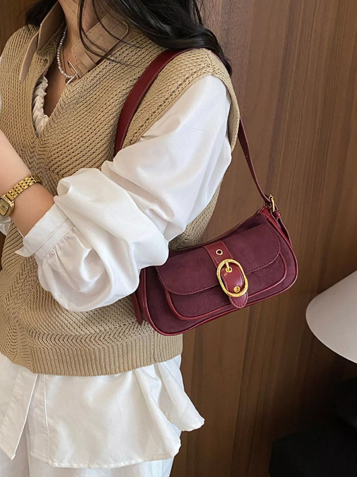 Wine red suede crossbody shoulder bag with front buckle clasp and adjustable strap