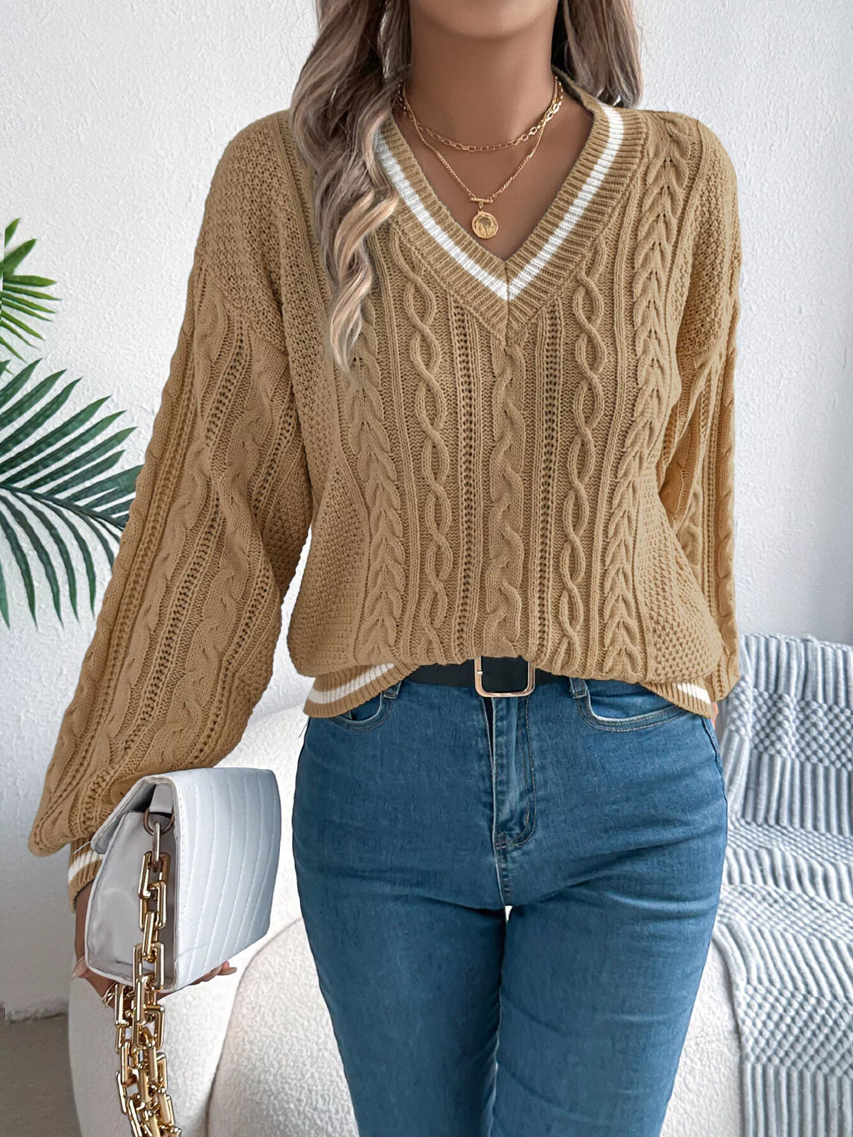 Khaki V-neck cable knit sweater with vertical cable stripes and ribbed trim