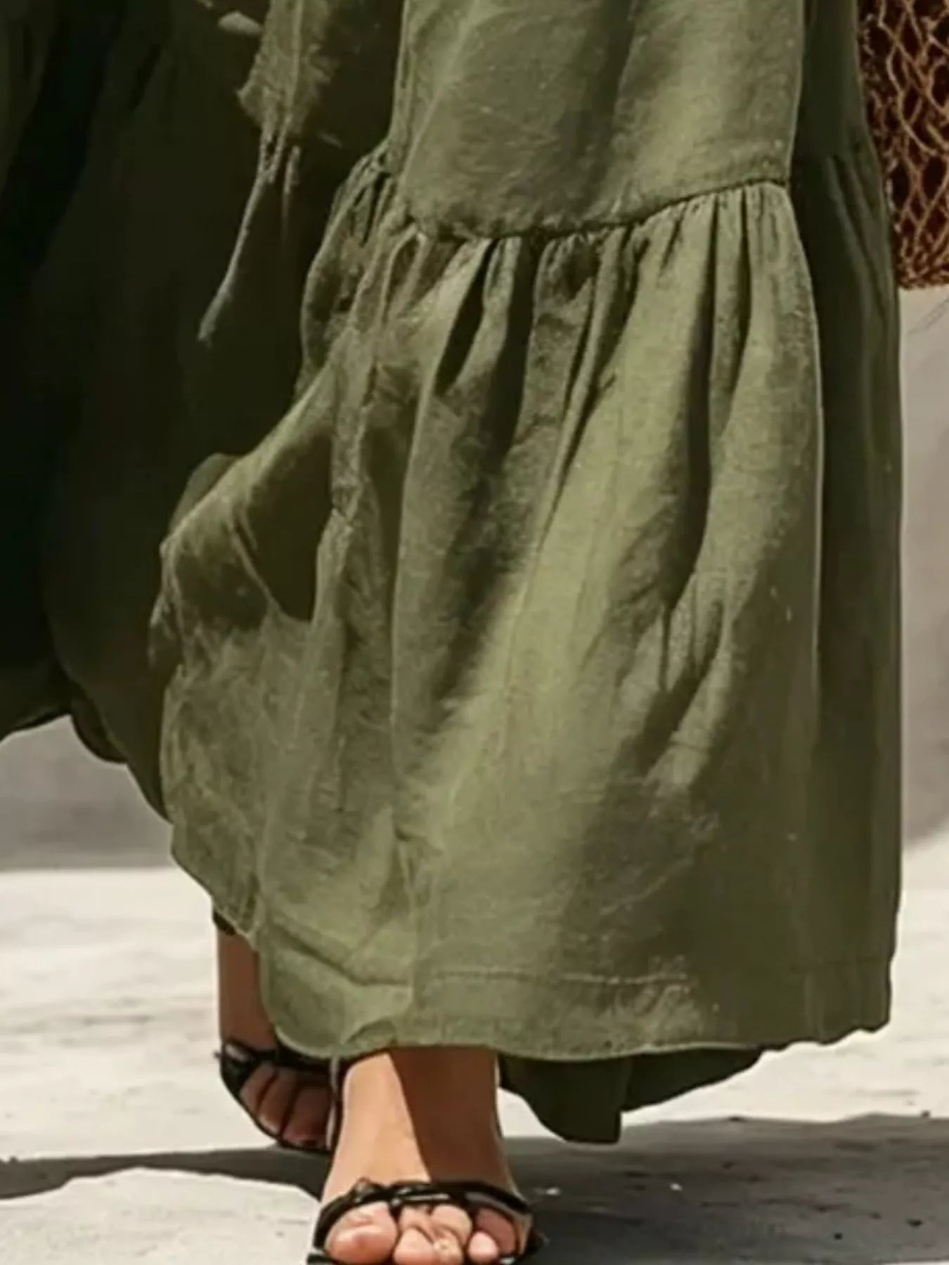 Close-up of army green tiered maxi skirt with ruched waist and layered ruffles.