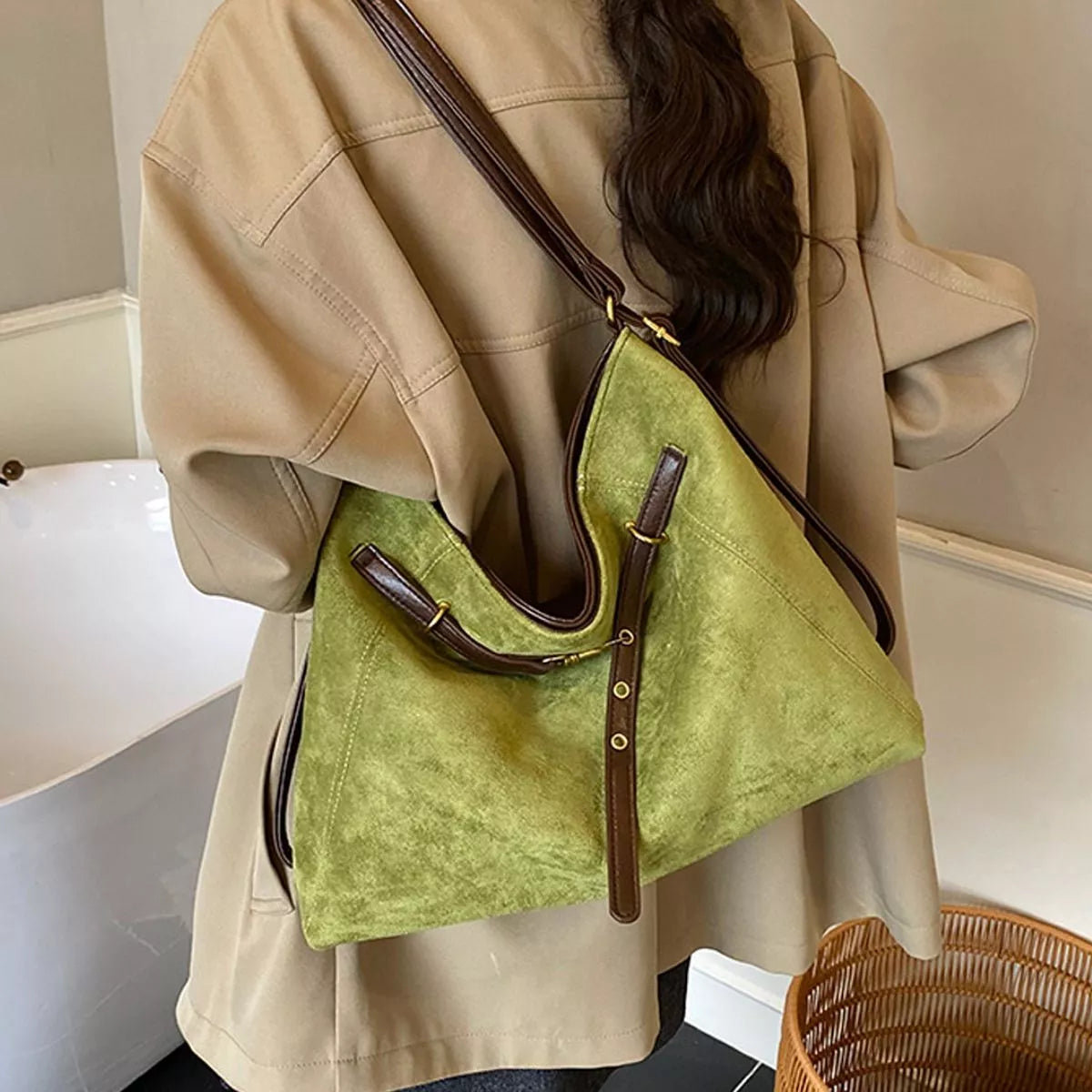 Medium green suede hobo shoulder bag with brown handles and crossbody strap